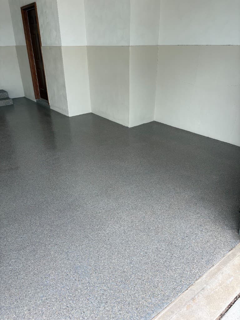 After coating: grey and blue flake garage floor with matching step finish.