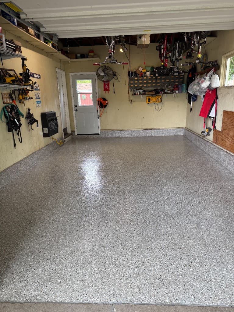 Refreshed garage floor finished in Creekbed flake coating.